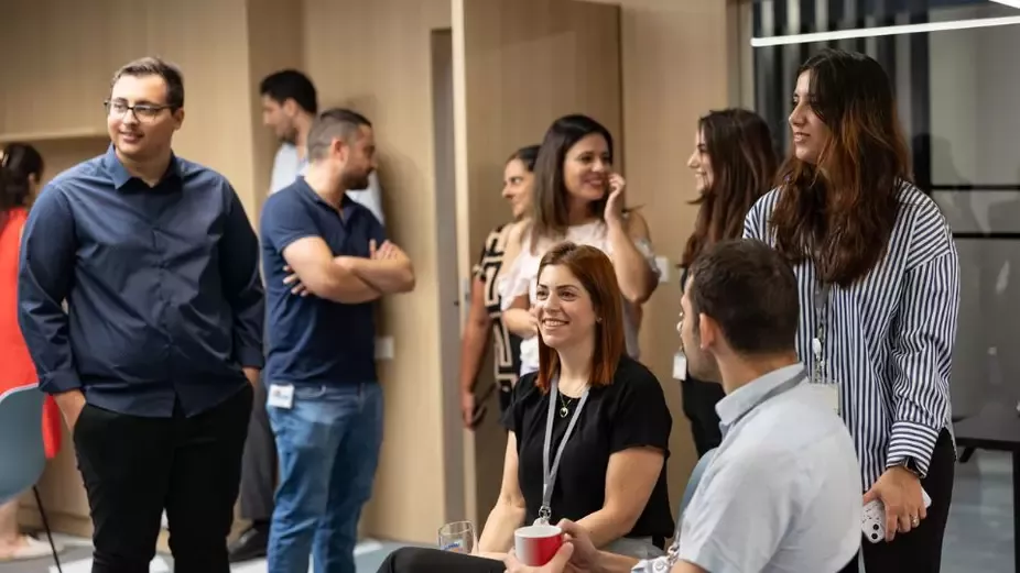 Employees networking and collaborating in a modern office workplace environment