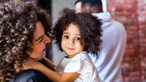 Afro-American family holding a child 