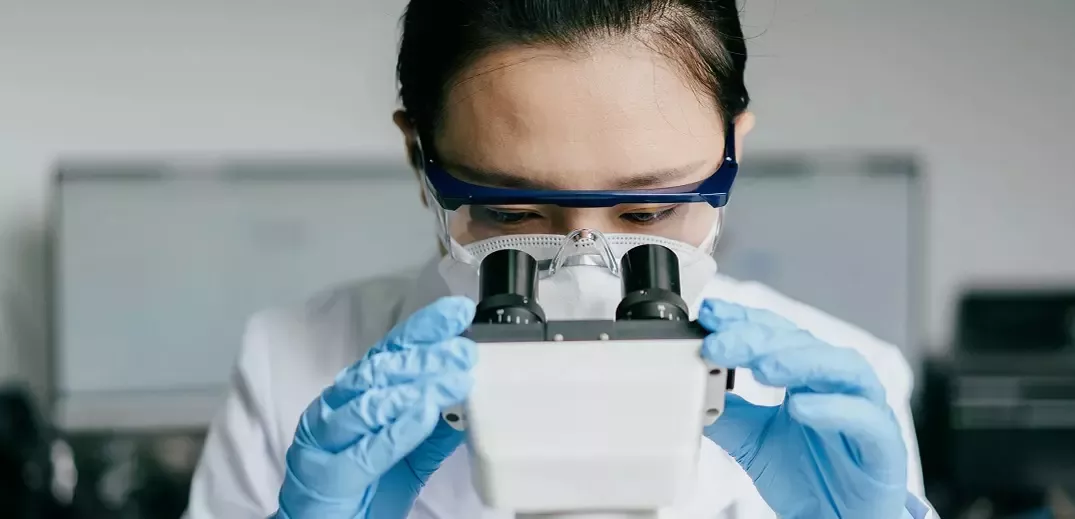 woman-scientist-looks-into-microscope-wide